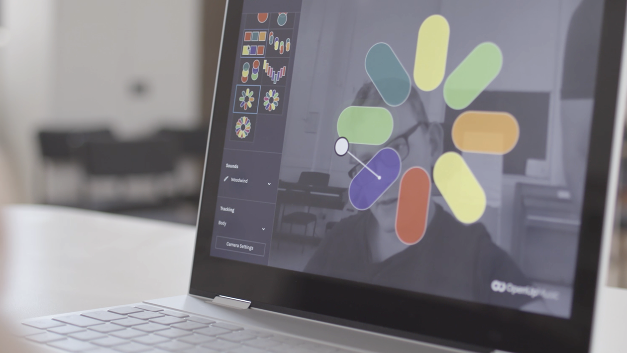 A photo of a user research participant with cerebral palsy creating music with creatability